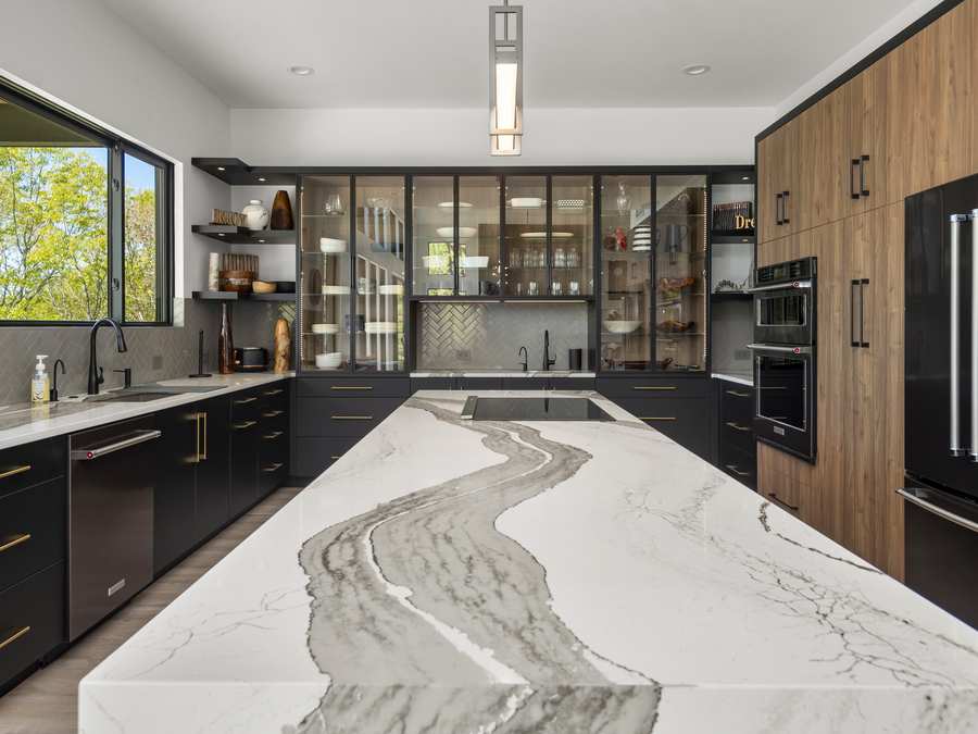 Modern kitchen, marble island and walnut cabinetry