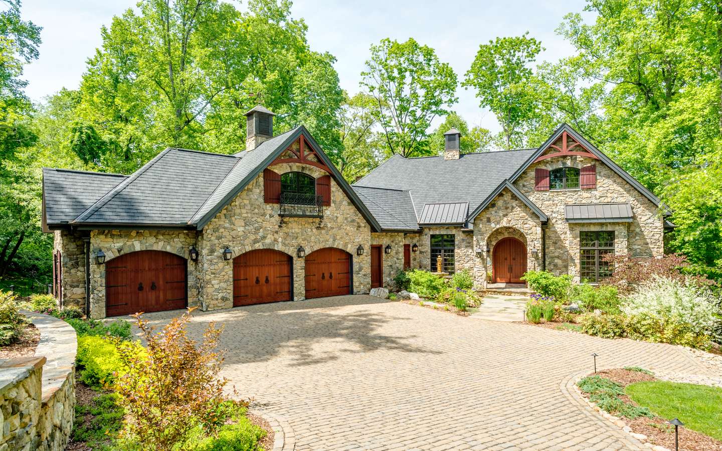 A stone custom home from its motor court